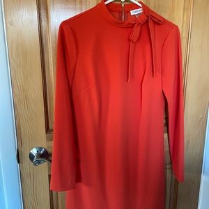 Orange Calvin Klein shift dress with bow embellishment